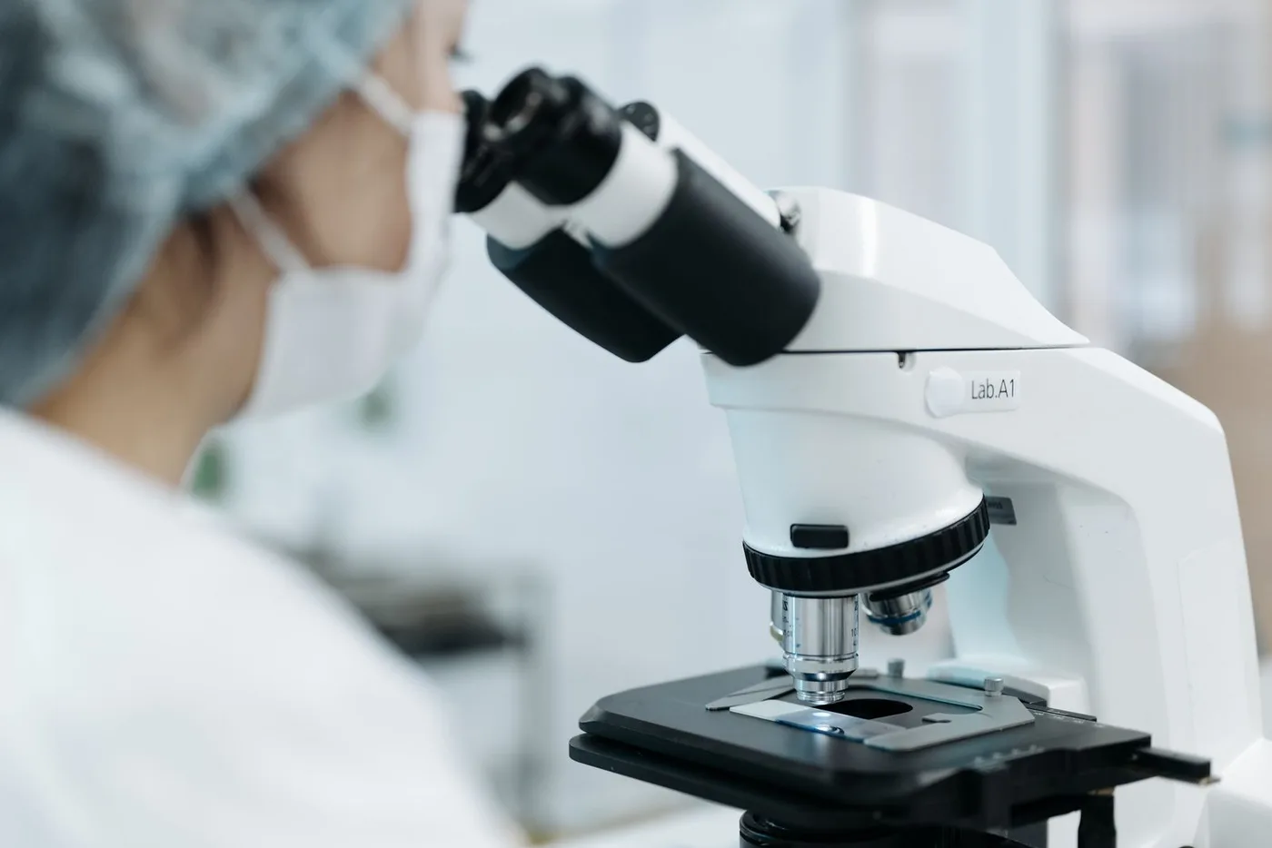 A researcher at a microscope
