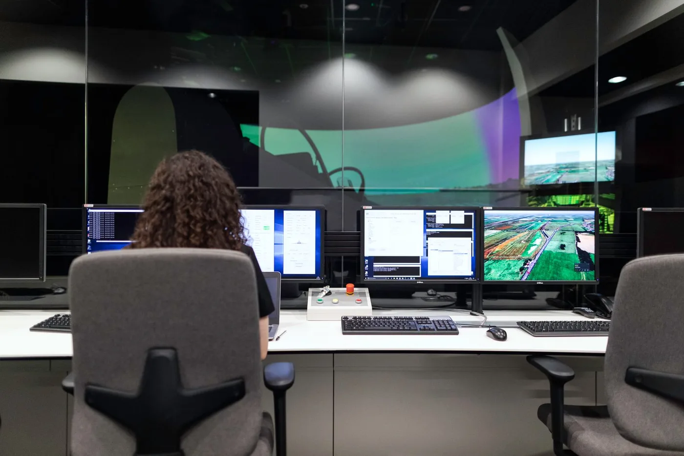 An engineer monitoring several screens at once