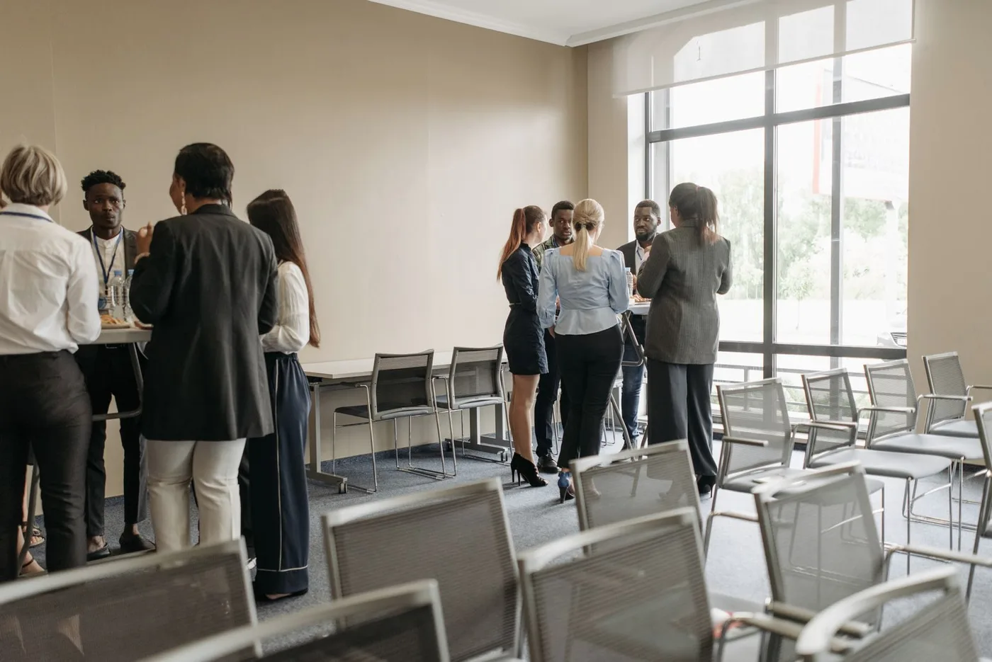 People mingling in small groups at an office gathering