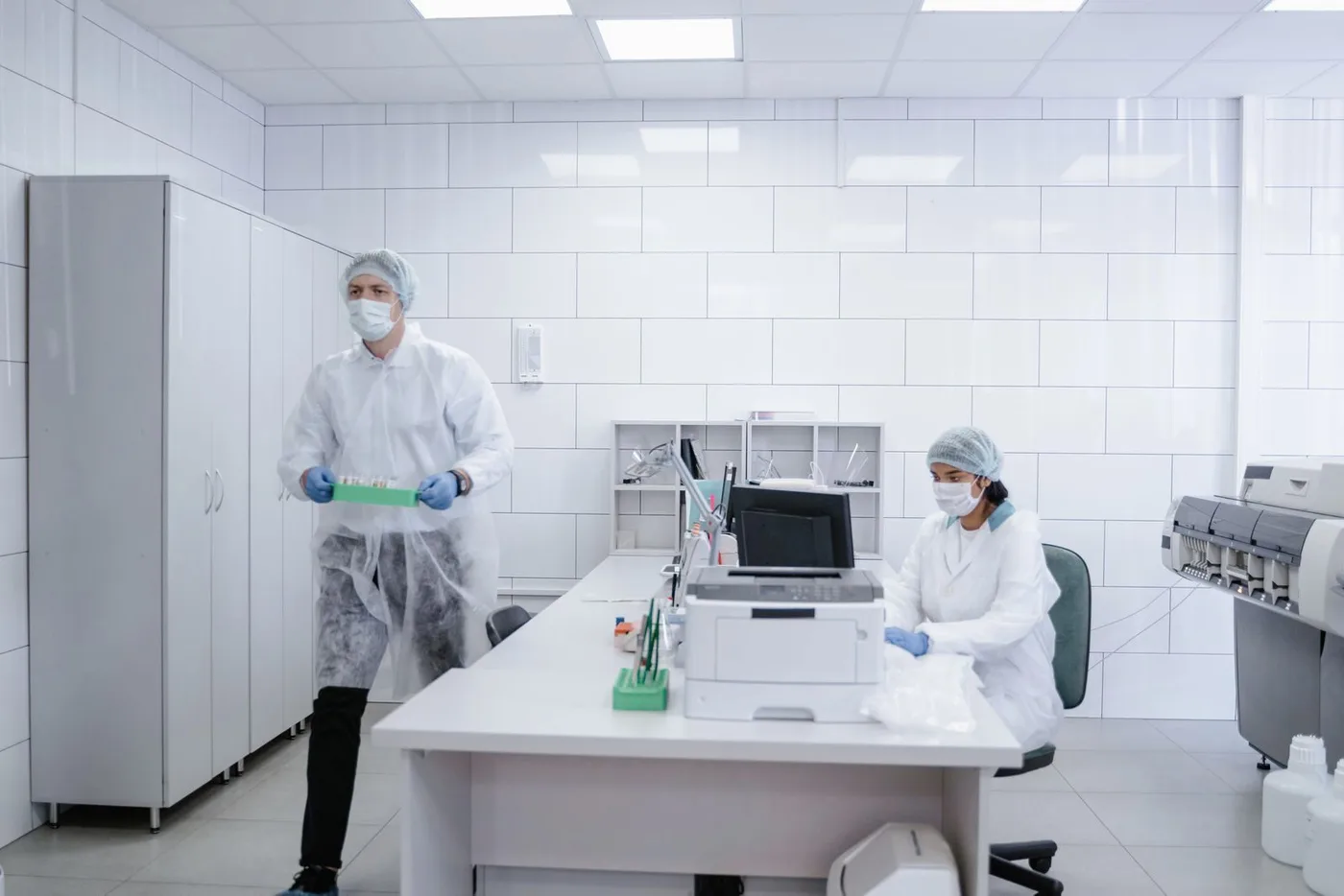 Scientists in protective gear working in a laboratory